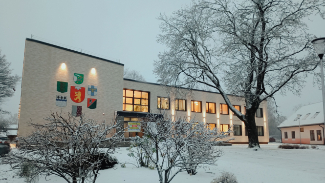 Gaiša divstāvīga ēka sniegotā ziemas ainavā