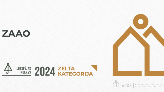 Baneris ar zeltainu māju siluetu