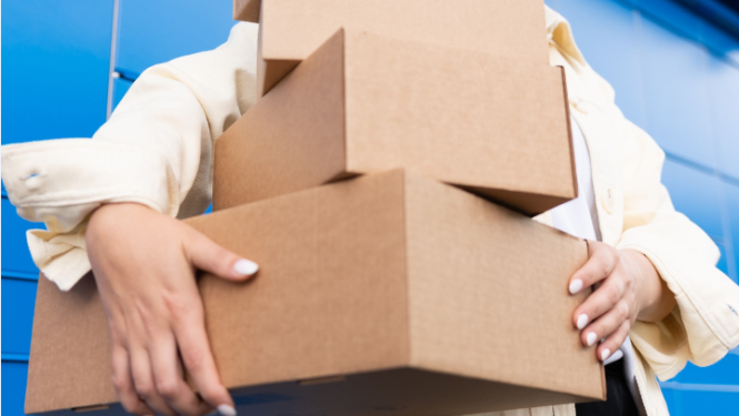 Cilvēks, kas rokās tur sūtijumu pakas