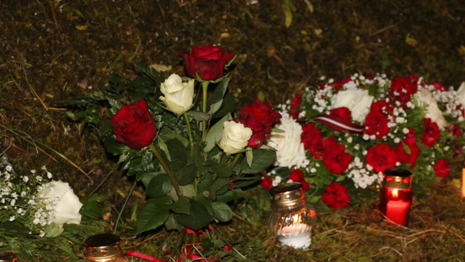 Sarkanbaltsarkani ziedi un iedegtas kapu sveces